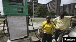 A man buys fuel at a petrol station in Lagos, Nigeria, April 24, 2012. 