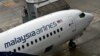 FILE - A Malaysia Airlines staff walks up to a flight prior to departure at the Kuala Lumpur International Airport in Sepang, May 14, 2014. 