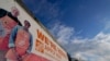 FILE - A sign announcing hiring is displayed in the parking lot of a Home Depot, Feb. 22, 2021, in Cockeysville, Md. 