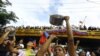 TOPSHOT - A man bangs a cooking pot during a protest against Venezuelan President Nicolas Maduro's government in Valencia, Carabobo state, Venezuela on July 29, 2024, a day after the Venezuelan presidential election.