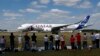 FILE - Visitors watch an Airbus A350 XWB takes off for a flying display during the Farnborough International Air Show, Farnborough, England, July 14, 2014.