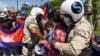 Local security personnel guards confiscate a loudspeaker from a protester during a protest to mark the 29th anniversary of the Paris Peace Accord in front of the US embassy in Phnom Penh on October 23, 2020. (Photo by TANG CHHIN Sothy/AFP)