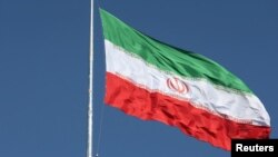 FILE - The Iranian flag is seen flying over a street in Tehran, Iran, February 3, 2023. Majid Asgaripour/WANA (West Asia News Agency) 