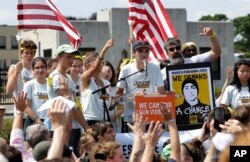 FILE - David Hogg (C) a survivor of the school shooting at Marjory Stoneman Douglas High School, in Parkland, Florida, addresses a rally in front of the headquarters of gun manufacturer Smith & Wesson, in Springfield, Massachusetts, Aug. 26, 2018.