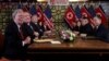 John Bolton, left, and others attend an extended bilateral meeting between North Korea's leader Kim Jong Un and U.S. President Donald Trump, in Hanoi, Vietnam Feb. 28, 2019. 