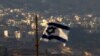 FILE - An Israeli flag flies near the village of Majdal Shams in the Israeli-controlled Golan Heights, Oct. 11, 2018.