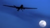 U.S. Predator drone flies over the moon above Kandahar Air Field, southern Afghanistan, January 2010.