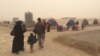 On the day Abu Yousef, his wife and their four children arrived at the Khazir camp, a sand storm hit, forcing the exhausted refugees to race into tents, Iraqi Kurdistan, Nov. 1, 2016. (H.Murdock/VOA)