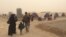 On the day Abu Yousef, his wife and their four children arrived at the Khazir camp, a sand storm hit, forcing the exhausted refugees to race into tents, Iraqi Kurdistan, Nov. 1, 2016. (H.Murdock/VOA)