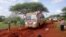 Kenyan security forces and others gather around the scene on an attack on a bus about 50 kilometers outside the town of Mandera, near the Somali border in northeastern Kenya, Nov. 22, 2014.