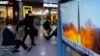 A TV shows a file image of North Korea's missile launch during a news program at the Seoul Railway Station in Seoul, South Korea, Jan. 11, 2022.
