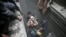 Syria Civil Defense members help an unconscious woman from a shelter in the besieged town of Douma, Eastern Ghouta, Damascus, Syria, Feb. 22, 2018. 