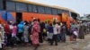 FILE - People board a commercial bus to flee following attacks by Boko haram in Bama and other parts of Maiduguri, Nigeria, Sept. 8, 2014. 