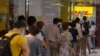 People queue up outside the DHL Express store in Hong Kong, Monday, June 1, 2020. Throngs of people lined up at DHL courier outlets across the city on Monday, many to send documents to the U.K. to apply for or renew what is known as a British…
