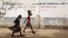 FILE - Girls walk on a road in Maroua, Cameroon, March 17, 2016. Menstruation remains stigmatized in Cameroon and the cost of sanitary pads out of reach for many woman and girls.