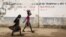 FILE - Girls walk on a road in Maroua, Cameroon, March 17, 2016. Menstruation remains stigmatized in Cameroon and the cost of sanitary pads out of reach for many woman and girls.
