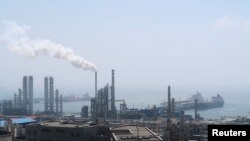 China National Petroleum Corporation (CNPC)'s Dalian Petrochemical Corp refinery is seen near the downtown of Dalian in Liaoning province, China July 17, 2018.