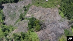 A deforested hill is visible near an area affected by a flash flood in Pesisir Selatan, West Sumatra, Indonesia, Thursday, March 14, 2024. (AP Photo/Sutan Malik Kayo)