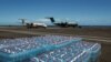 Supplies to be transported to Mayotte lie on the tarmac near parked aircrafts, in the aftermath of Cyclone Chido, at the military airbase 181 in Sainte Marie in Reunion Island, France, Dec. 17, 2024. 