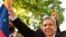 Venezuelan opposition leader Edmundo Gonzalez Urrutia holds a Venezuelan flag as he greets supporters after a meeting with Uruguay's President Luis Lacalle Pou in Montevideo, Uruguay, Jan. 4, 2025.