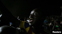 A supporter of Central African Republic's United Hearts Movement (MCU) party celebrates the victory of President Faustin-Archange Touadera outside their party offices, in Bangui, Central African Republic, Jan. 4, 2021. 
