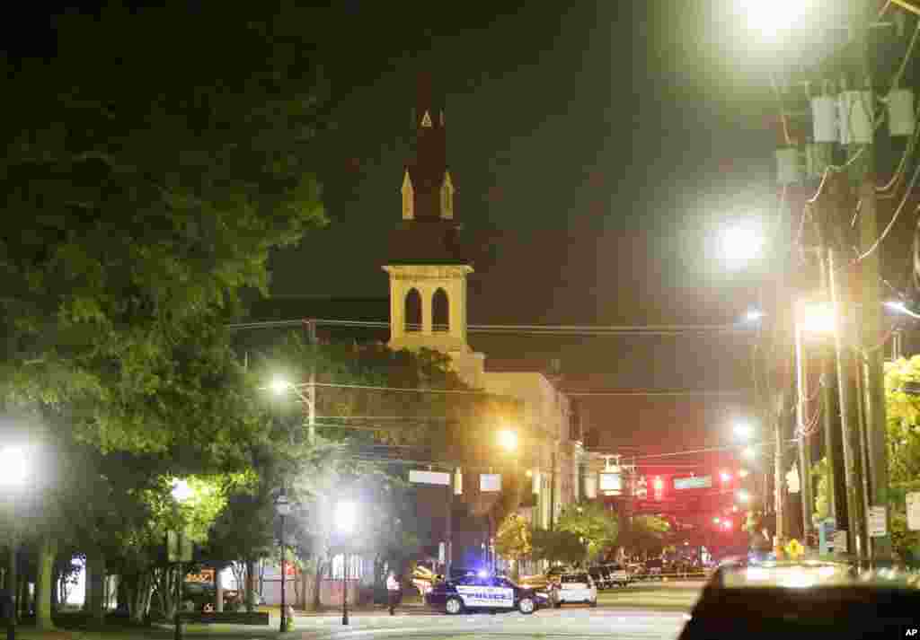 The steeple of Emanuel AME Church is visible as police close off a section of Calhoun Street early Thursday, June 18, 2015.