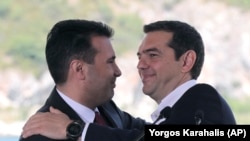 GREECE -- Greek Prime Minister Alexis Tsipras, right and his Macedonian counterpart Zoran Zaev, embrace during a signing of an agreement for Macedonia's new name in the village of Psarades, June 17, 2018