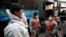 South Korean soldiers in protective gear talk as they disinfect on the street as a precaution against the new coronavirus in Seoul, South Korea, March 12, 2020. 