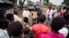 FILE - A Ugandan government official briefs newly arrived refugees on the laws of Uganda.