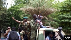 Malian soldiers drive through the streets of Bamako, Mali, Aug. 19, 2020, the day after rebel troops seized Malian President Ibrahim Boubacar Keita and Prime Minister Boubou Cisse in a dramatic escalation of a months-long crisis. 
