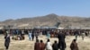 Hundreds of people gather near a U.S. Air Force C-17 transport plane at the perimeter of the international airport in Kabul, Afghanistan, Aug. 16, 2021.