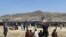 Hundreds of people gather near a U.S. Air Force C-17 transport plane at the perimeter of the international airport in Kabul, Afghanistan, Aug. 16, 2021.