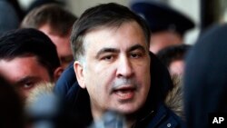 FILE - Former Georgian President Mikheil Saakashvili speaks with journalists near the Fairmont Grand Hotel in Kyiv, Ukraine, Feb. 9, 2018. Saakashvili claimed that unidentified armed people wearing military uniforms tried to arrest him inside the hotel.