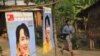 A man wearing a T-shirt bearing the image of Aung San Suu Kyi dances at campaign rally for the pro-democracy icon and her National League for Democracy, Rangoon, Burma, March 30, 2012. 