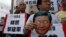 Protester holds mask of Chinese President Xi Jinping during demonstration for Chinese journalist Gao Yu, Hong Kong publisher Yao Wentian, and Chinese lawyer Pu Zhiqiang, Chinese liaison office, Hong Kong, May 11, 2014.
