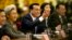 Chinese Premier Li Keqiang, center, smiles as he answers a reporter's question during a press conference at the end of the National People's Congress in Beijing's Great Hall of the People, March 15, 2015. 