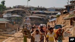Rohingya refugees rebuild their makeshift houses, in preparation for the approaching monsoon season, at the Kutupalong Rohingya refugee camp in Kutupalong, Bangladesh, April 28, 2018.