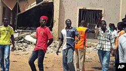 A displaced man sits on the ruins of a destroyed building outside Hammam al-Alil camp, south of Mosul, Iraq.