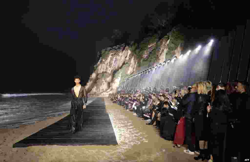 A model presents a creation during the Saint Laurent Men's Spring-Summer 2020 runway show in Malibu, California, on June 6, 2019.