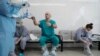 FILE - A doctor gets ready to put on protective gear before his shift at an intensive care unit of the Filatov City Clinical Hospital in Moscow, Russia, May 15, 2020. 