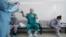 FILE - A doctor gets ready to put on protective gear before his shift at an intensive care unit of the Filatov City Clinical Hospital in Moscow, Russia, May 15, 2020. 