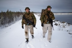 Patrol leader Joergen Aas (L) and radio operator Thomas Lundmann patrol the Norwegian side of the Norway-Russia border in Pasvik valley, Finnmark county, Norway, Oct. 23, 2019.