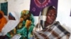 FILE - Hawo Jibril Ahmed (R), a former rape victim sits with other Somali women, inside the Somali women development center in Mogadishu, Dec. 31, 2012.
