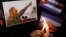 People place candles beside a picture of Fidel Castro, as part of a tribute, following the announcement of the death of the Cuban revolutionary leader, in Tegucigalpa, Honduras, Nov. 26, 2016.