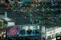 FILE - Personal belongings and debris litters the Route 91 Harvest festival grounds across the street from the Mandalay Bay resort and casino in Las Vegas, Oct. 3, 2017.