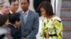 U.S. first lady Michelle Obama, right, is greeted by an unidentified Japanese official upon her arrival at Haneda International Airport in Tokyo, March 18, 2015. 
