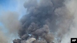 Blackened forest is left behind as large wildfire burns near Magnolia, Texas. More than 1,000 homes have been destroyed in at least 57 wildfires across rain-starved Texas, most of them in one devastating blaze near Austin that is still raging out of con