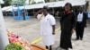 FILE - Liberian Minister of Justice Christine Tah (center right) observes a moment of silence with a senior female police officer at a 2011 ceremony for fallen peacekeepers.