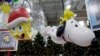Models of a new balloons, Sponge Bob Square Pants, left, and Snoopy with Woodstock, the bird atop, are displayed during a preview of new Macy's Thanksgiving Day Parade floats and balloons in Moonachie, N.J., Nov. 19, 2013.