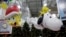 Models of a new balloons, Sponge Bob Square Pants, left, and Snoopy with Woodstock, the bird atop, are displayed during a preview of new Macy's Thanksgiving Day Parade floats and balloons in Moonachie, N.J., Nov. 19, 2013.